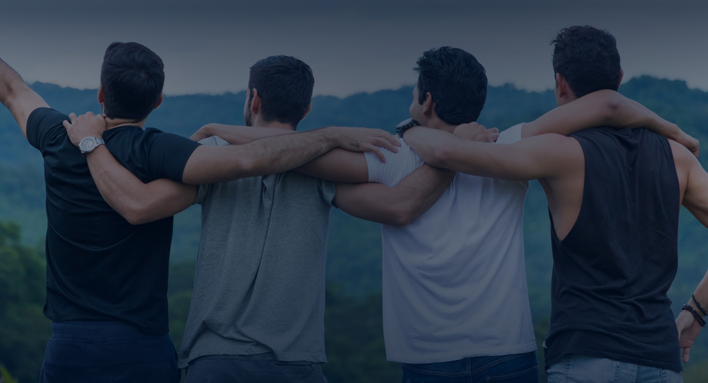 Group of friends with arms wrapped around shoulders