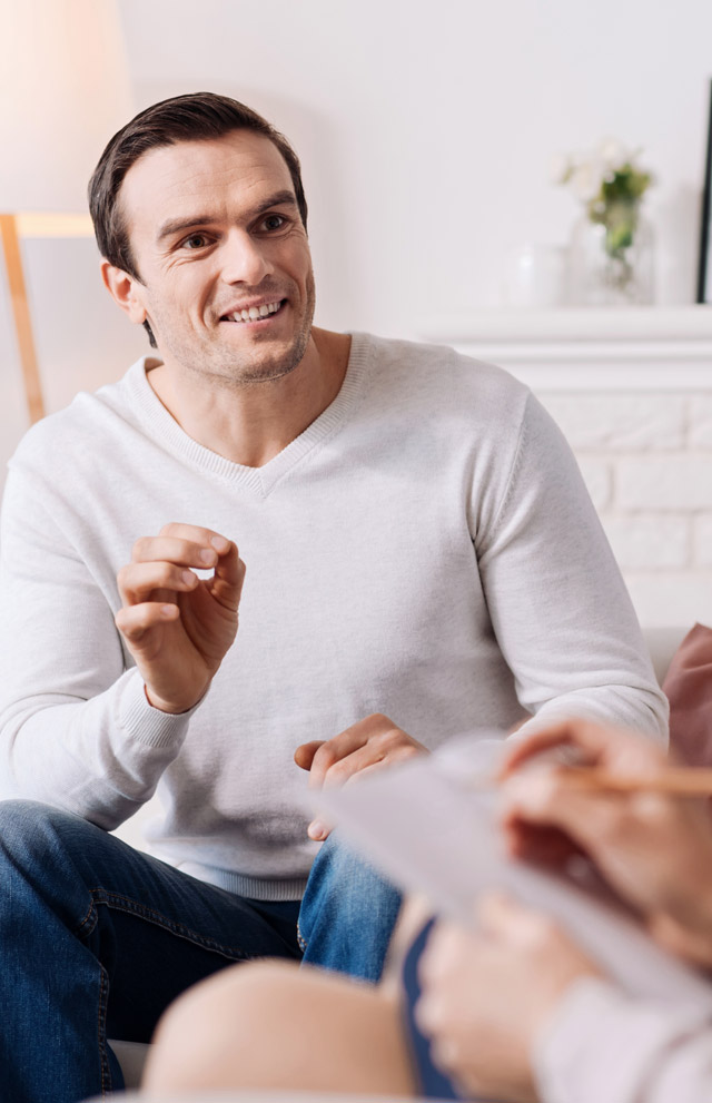 Cheerful man talking to therapist