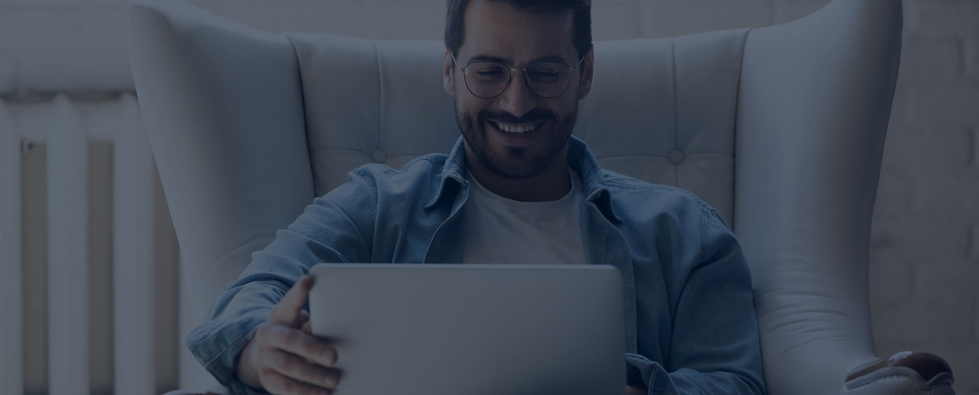 Happy man looking at laptop