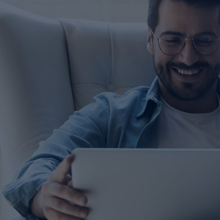 Happy man looking at laptop