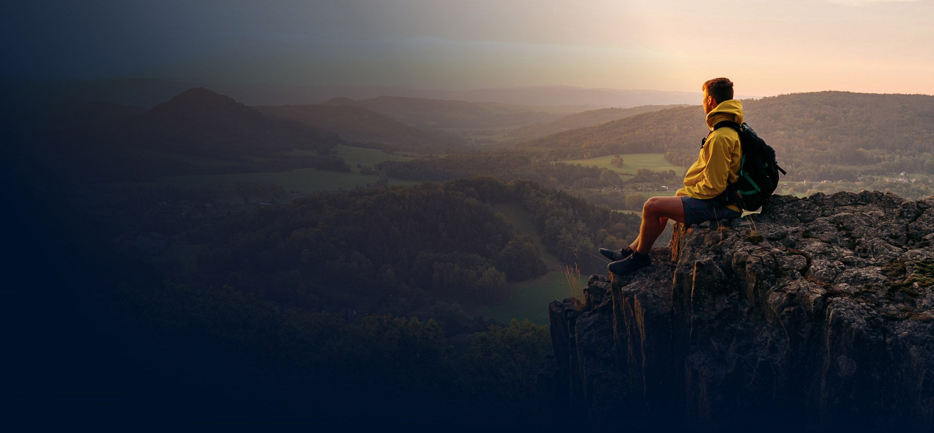 Hiker overlooks beautiful city at sunrise