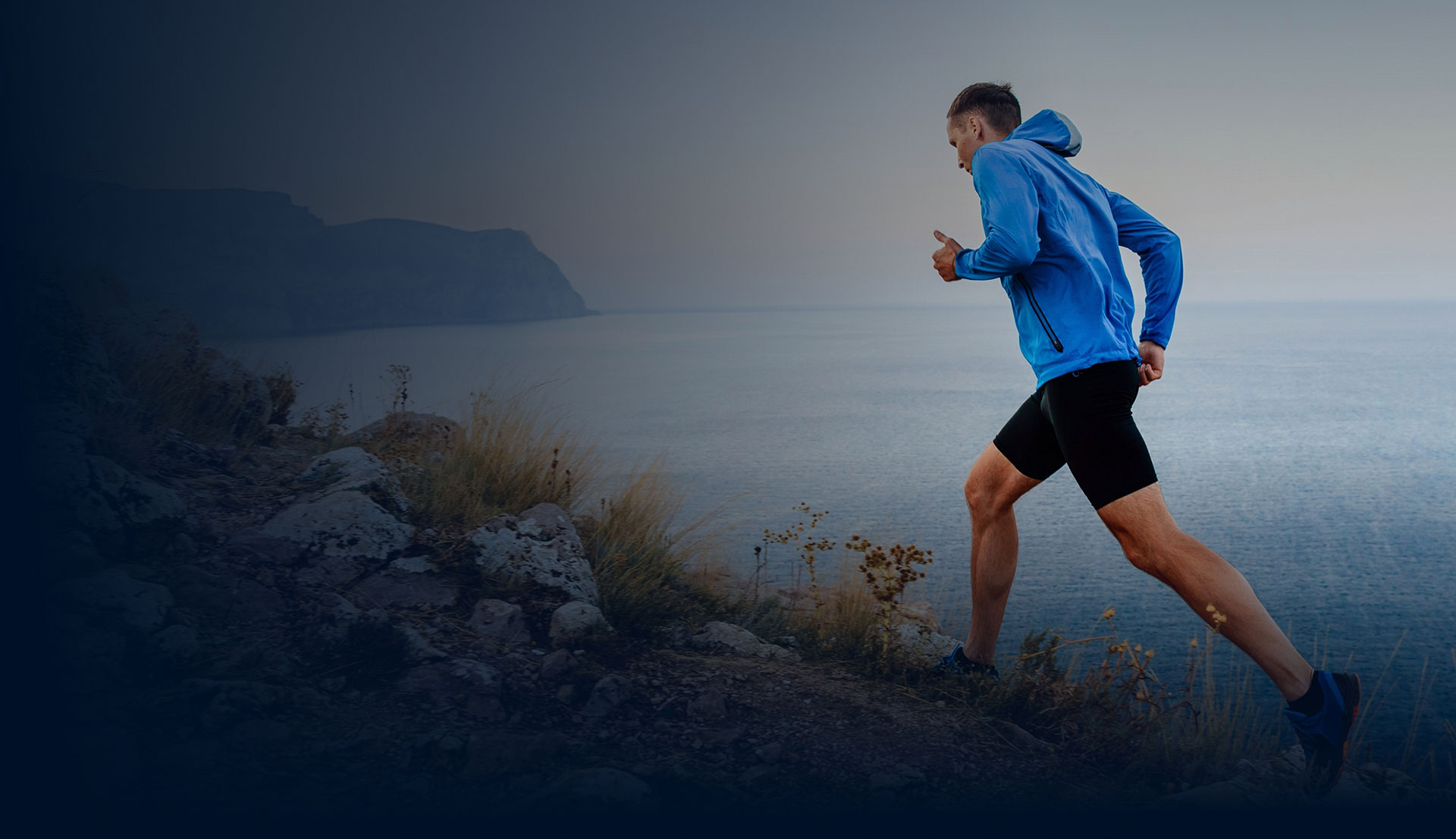 Man jogging along lake path