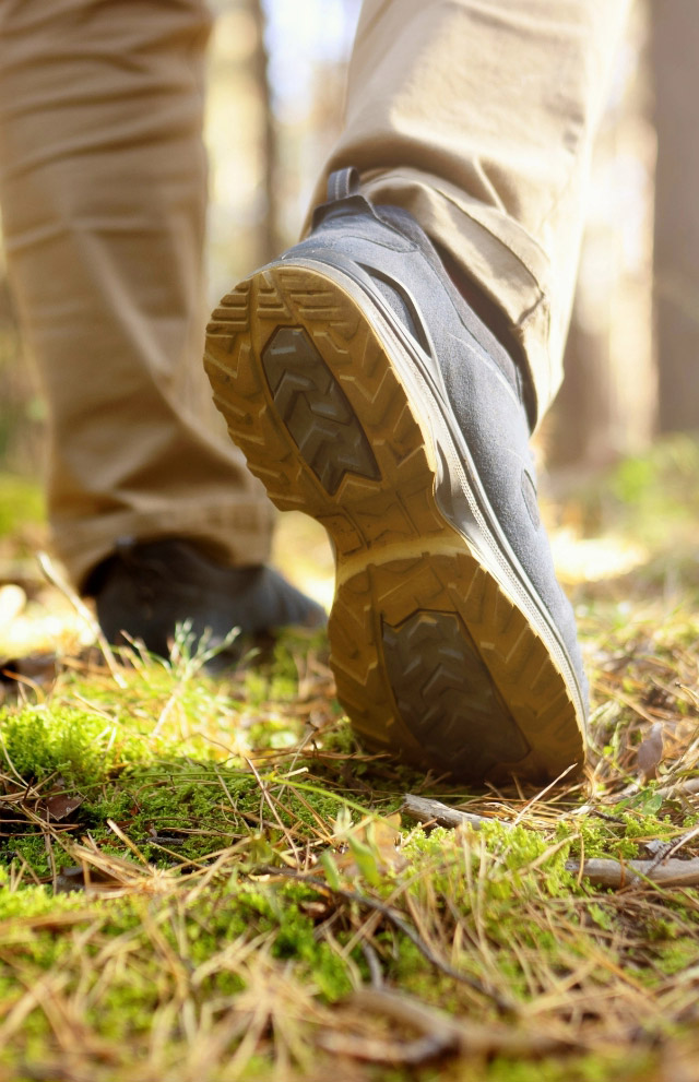 Mens footstep hiking in woods