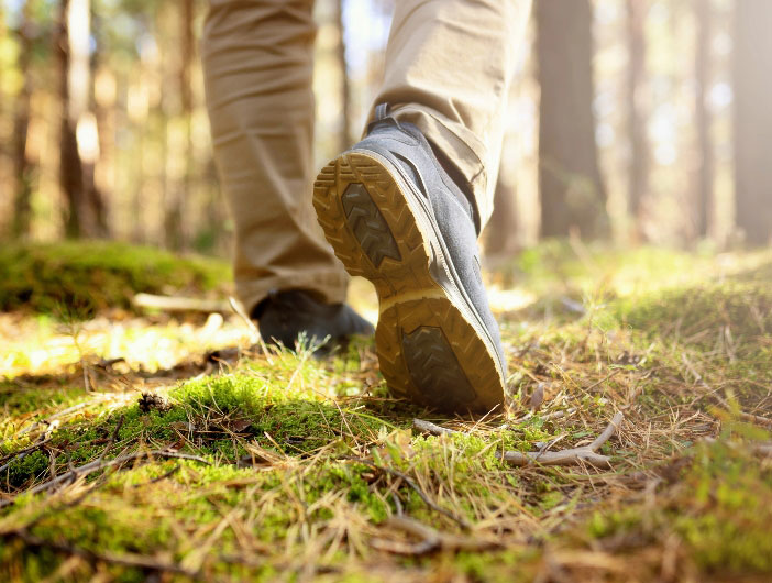 Mens footstep hiking in woods