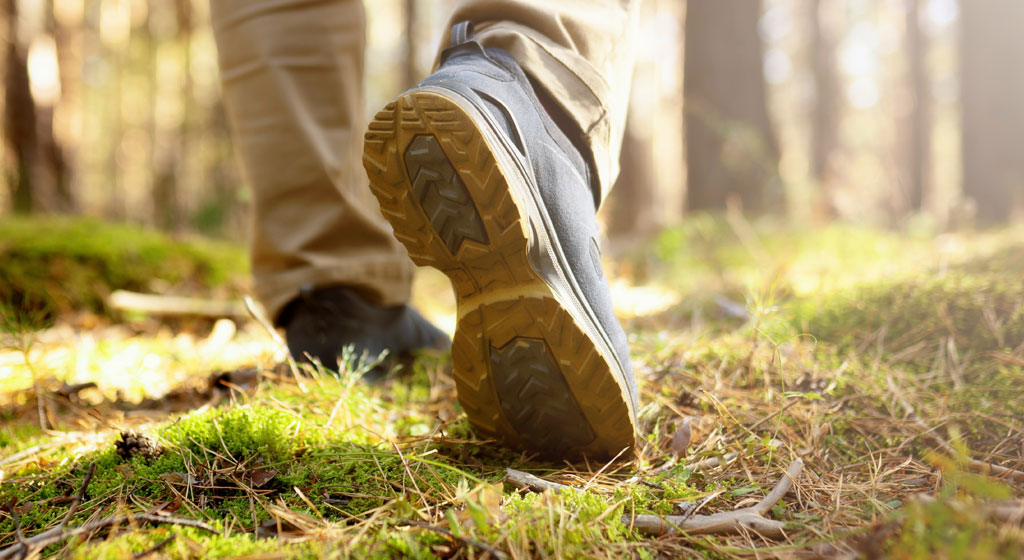 Mens footstep hiking in woods