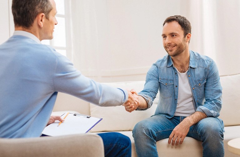 Two men shaking hands stress therapy