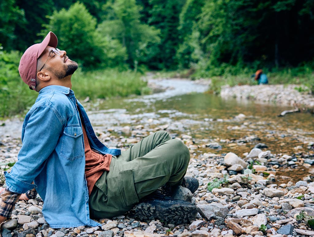 Man relaxing by river